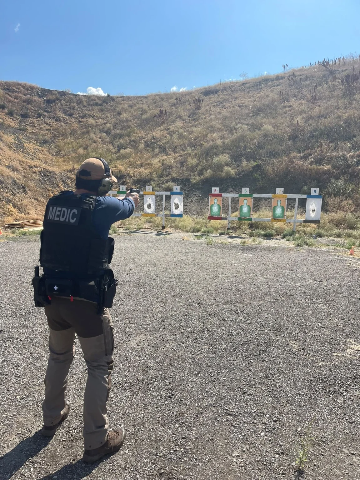 Advisor conducting handgun training at an outdoor range